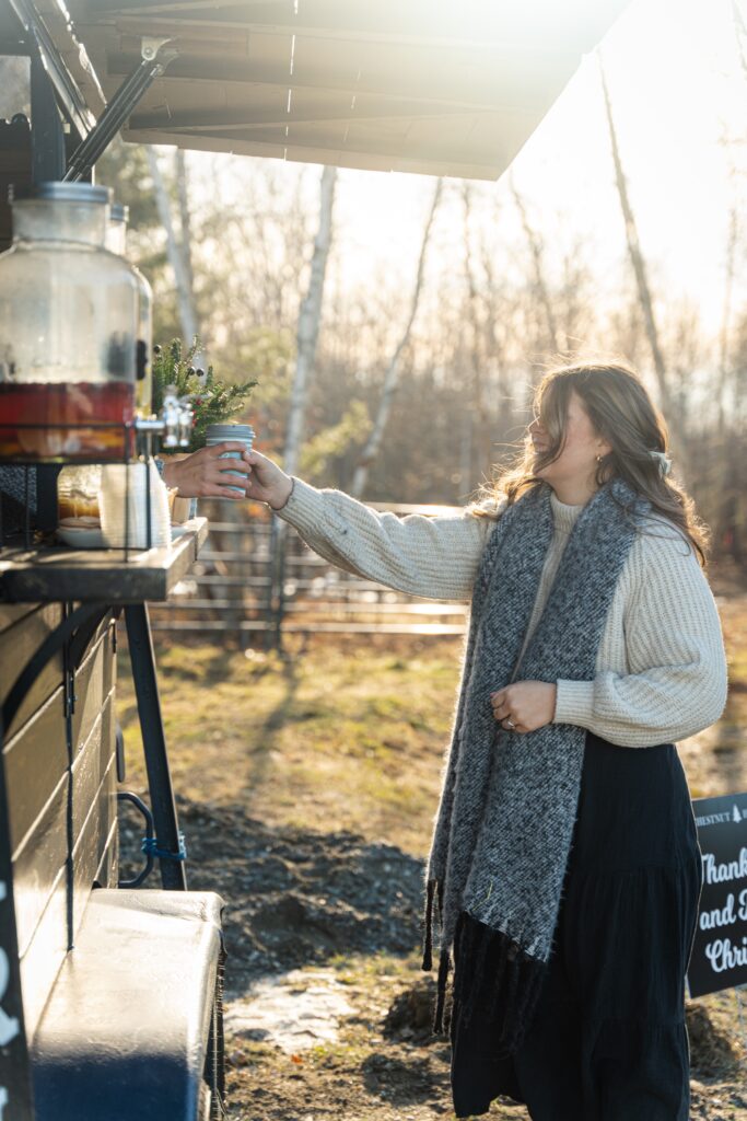 Woman getting a drink at Eido Bar Company's bar trailer