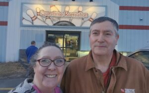 Donna Oliver and husband in front of Interstate Bowling & Town Line Sports Grille