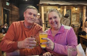 Donna Oliver and husband in front of Interstate Bowling & Town Line Sports Grille