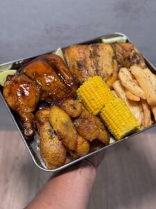 Tray of meats, corn, and potatoes served at New England Iron Pollo