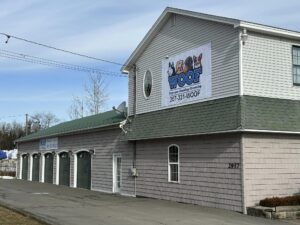 Large tan building which houses Woof Daycare & Boarding